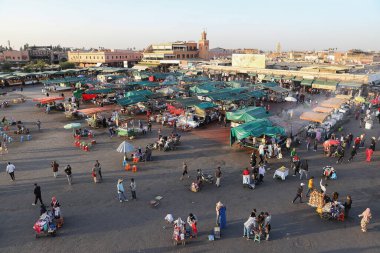 MARRAKESH, MOROCCO - OCTOBER 29, 2021: People in Jemaa el-Fnaa where main square of Marrakesh, used by locals and tourists
