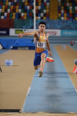 ISTANBUL, TURKEY - JANUARY 16, 2022: Undefined athlete triple jumping during Turkish Athletic Federation Indoor Athletics Record Attempt Races