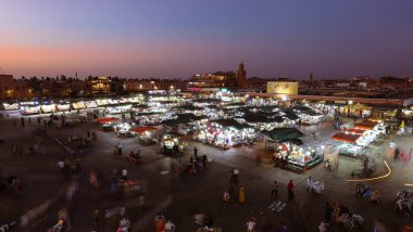MARRAKESH, MOROCCO - OCTOBER 29, 2021: People in Jemaa el-Fnaa where main square of Marrakesh, used by locals and tourists