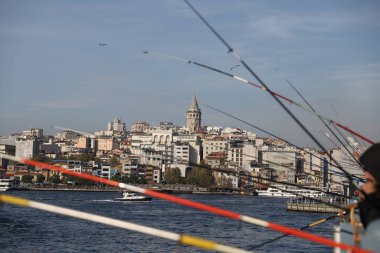 İSTANBUL, TURKEY - 23 Ekim 2021: Galata Köprüsü üzerinde balık tutan insanlar