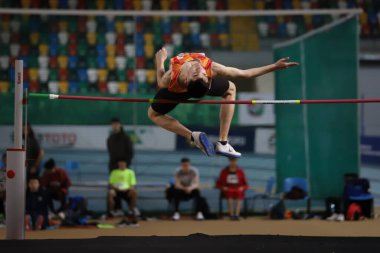 ISTANBUL, TURKEY - FEBRUARY 26, 2022: Undefined athlete high jumping during Turkish Indoor Athletics Championships in Atakoy Athletics Arena