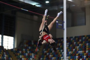 ISTANBUL, TURKEY - MARCH 05, 2022: Undefined athlete pole vaulting during Balkan Athletics Indoor Championships in Atakoy Athletics Arena