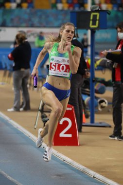 ISTANBUL, TURKEY - MARCH 05, 2022: Anita Horvat running 4x400 metres relay during Balkan Athletics Indoor Championships in Atakoy Athletics Arena