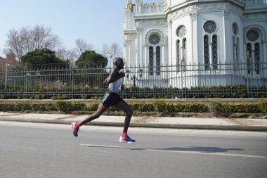 ISTANBUL, TURKEY - NOVEMBER 07, 2021: Athlete running Istanbul half marathon in historic street of Fener district