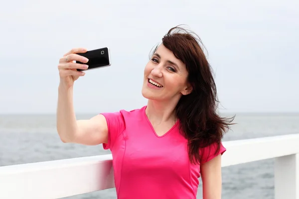 Woman showing display of her new touch mobile cell phone