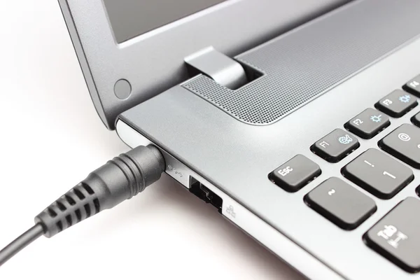 Plug adapter being connected to laptop computer — Stock Photo, Image