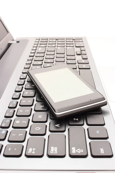 Mobile phone with laptop keyboard — Stock Photo, Image