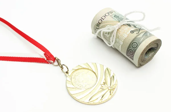 Gold medal and roll of tied banknotes on white background — Stock Photo, Image