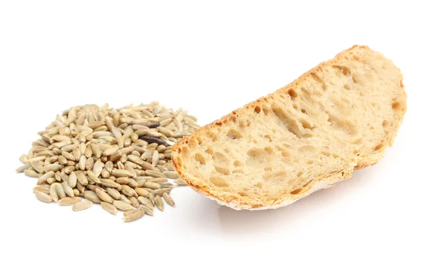 Rye grain and slice of bread on white background — Stock Photo, Image