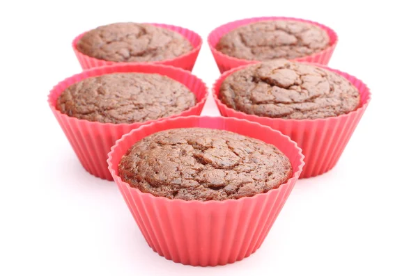 Fresh baked chocolate muffin in red silicone cups — Stock Photo, Image