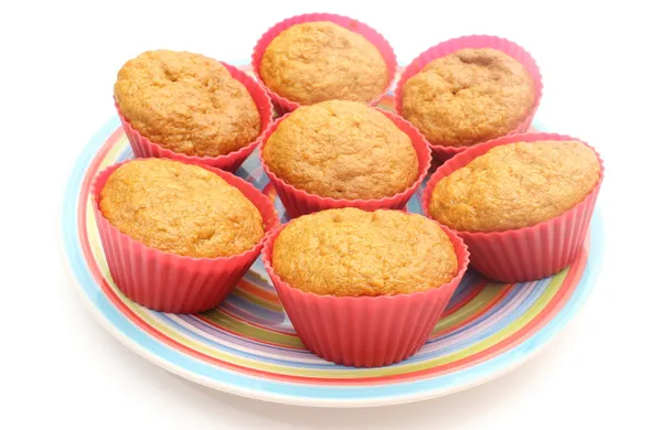 Fresh baked carrot muffins in red silicone cups — Stock Photo, Image