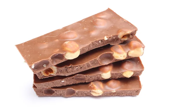 Fechar as peças de chocolate no fundo branco — Fotografia de Stock