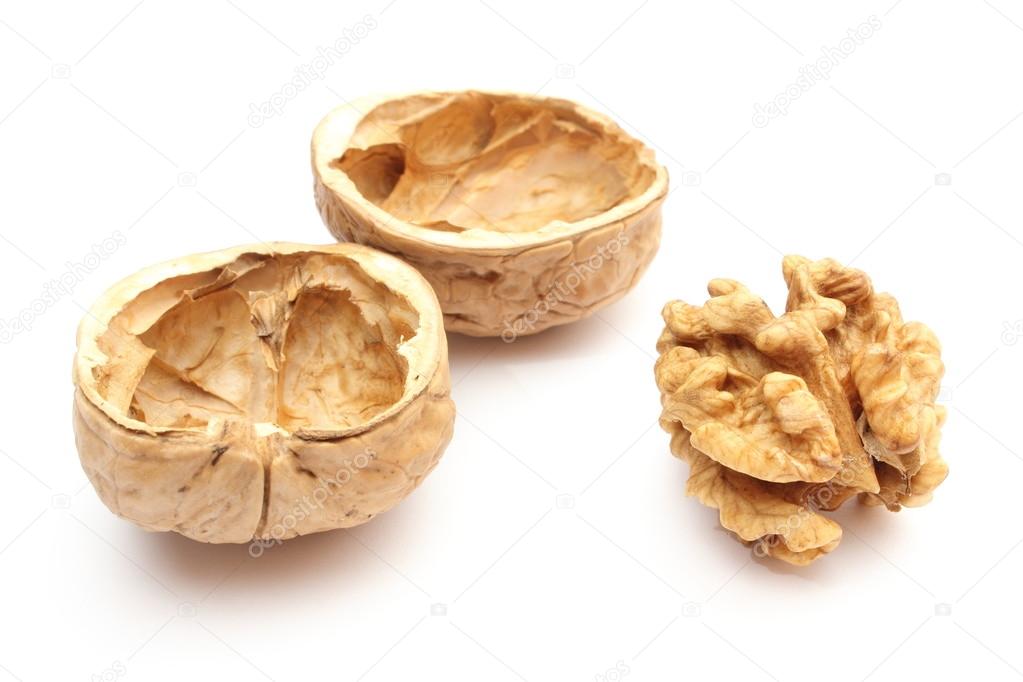 Walnut without shell and nutshells on white background