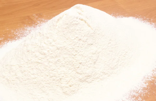 Heap of wheat flour on table — Stock Photo, Image