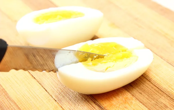 Sliced egg with knife — Stock Photo, Image