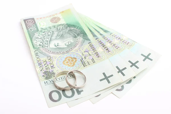 Wedding rings and money on a white background — Stock Photo, Image