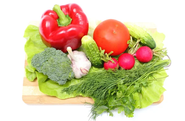 Fresh ripe raw vegetables on wooden cutting board — Stock Photo, Image