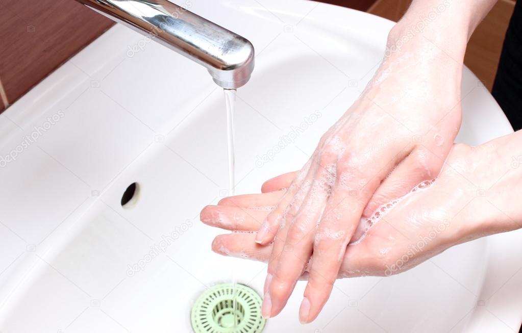 Washing of hands under running water