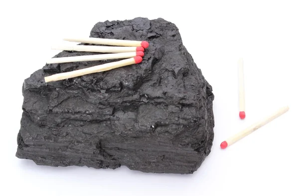 Coal lump with matches on white background — Stock Photo, Image