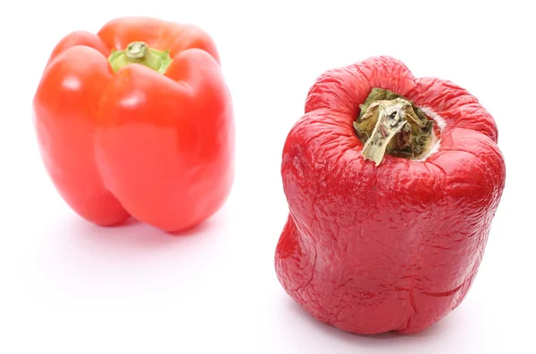 Fresh and wrinkled peppers on white background — Stock Photo, Image