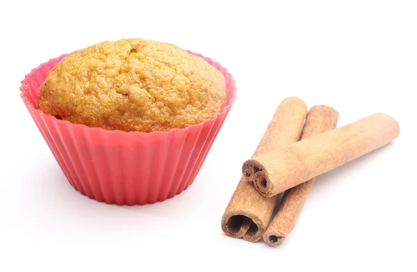 Fresh baked carrot muffin and cinnamon sticks. White background — Stock Photo, Image