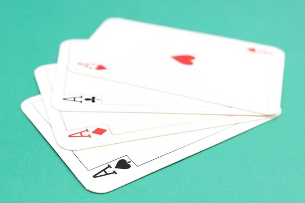 Composition of four aces on green background — Stock Photo, Image