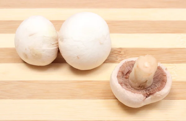 Champignons on wooden background — Stock Photo, Image