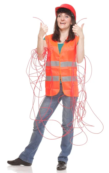 Mujer constructora en chaleco reflectante y cable rojo enredado —  Fotos de Stock