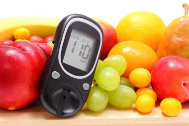 glikoz metre ve ahşap kesme tahtası üzerinde taze meyve