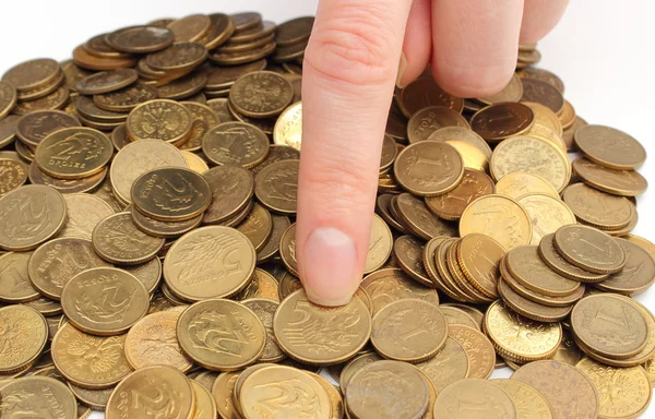Heap of old coins and finger of woman — Stock Photo, Image