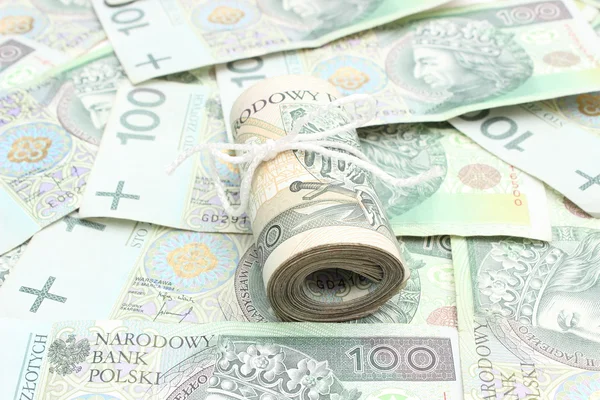 Rollo de billetes atados sobre fondo de dinero — Foto de Stock
