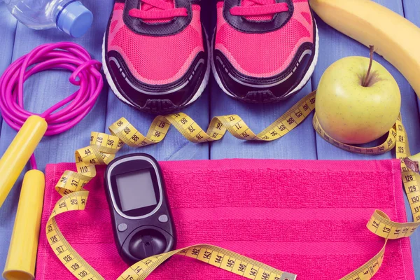 Glucometer with result of sugar level, pair of sport shoes and accessories for fitness. Diabetes and healthy sporty lifestyles