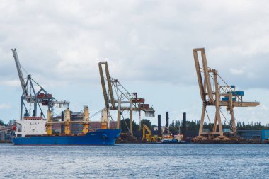 Swinoujscie, Batı Pomeranya - Polonya - 13 Haziran 2021: Baltık Denizi 'ndeki liman komplekslerine giren büyük vinçler ve gemilere bakın. Ulaşım, mal ve ürünlerin yeniden yüklenmesi