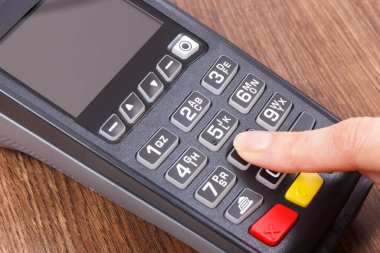 Ödeme terminali ve parmak kodu girildi. Nakitsiz ödeme için kullanılan kredi kartı okuyucu. Finans kavramı