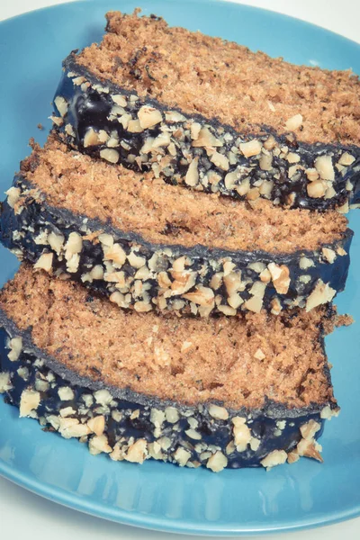 Pieces of zucchini dough with nuts and raisins. Delicious dessert. White background