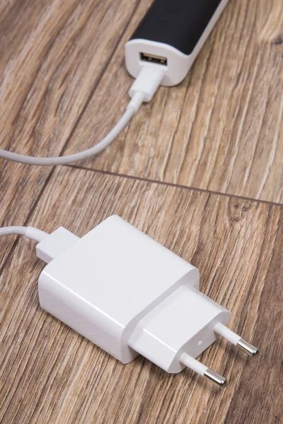 White charger and external powerbank using to charge empty battery of smartphone or other device