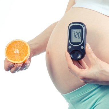 Vintage Fotoğraf, taze turuncu ve şekeri ölçüm cihazı ölçüm şeker seviyesi sonucu, sağlıklı beslenme ve diyabet kavramı ile gebelik sırasında tutan hamile kadın