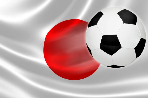 Le ballon de football sort du drapeau japonais — Photo
