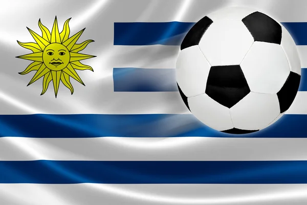 Bola de futebol sai da bandeira uruguaia — Fotografia de Stock