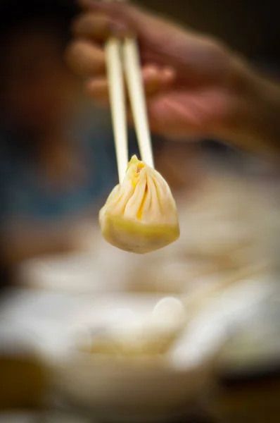 Chopsticks Holding Chinese Soup Dumpling Named Xiao Long Bao Defocused — Stock Photo, Image