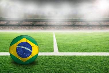 Brezilya 'nın boyalı bayrağıyla aydınlık bir stadyumda futbol. Arkaplanda sığ alan derinliği olan ön plan ve futbol topuna odaklan ve boşluğu kopyala.