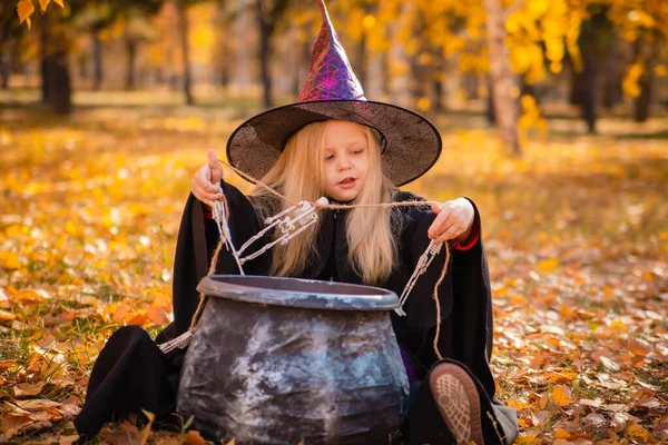 Piccola Ragazza Bionda Carina Vestita Strega Gioca Con Gli Scheletri — Foto Stock