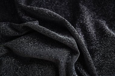 Pullu siyah kırışık kumaş. Sarılı kumaş. Parlak doku.