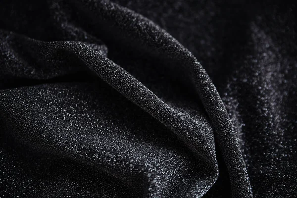 Pullu siyah kırışık kumaş. Sarılı kumaş. Parlak doku.