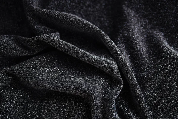 Pullu siyah kırışık kumaş. Sarılı kumaş. Parlak doku.