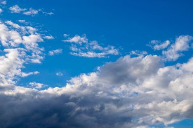 Dramatic blue sky and warm light clouds at sunrise time.