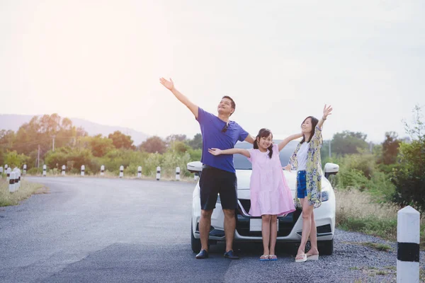 Concept of happy family travel by car. Freedom family with father,mother and daughter having fun on summer vacation