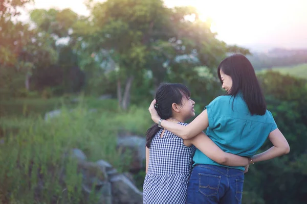Mother Daughter Hugging Having Fun Outdoor Green Nature Sunset Concept — kuvapankkivalokuva