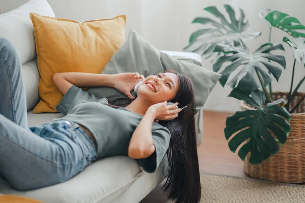 Happy Woman Relaxing Her Sofa Home Smiling Girl Listening Music — Foto de Stock