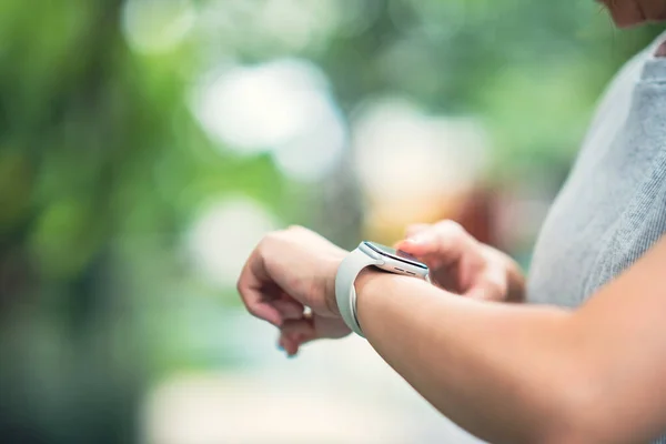 Woman using smart watches with checking pulse via health application. healthcare and people concept.